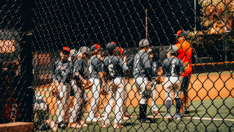 a group of men standing on top of a baseball field