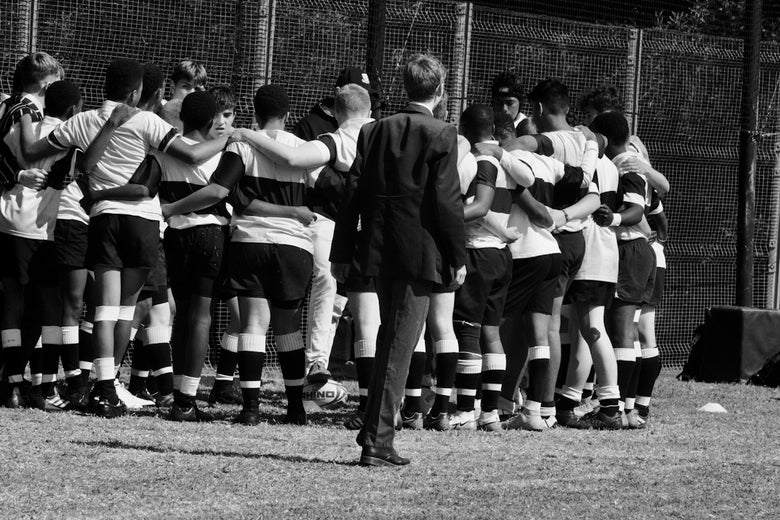 a group of football players huddled together