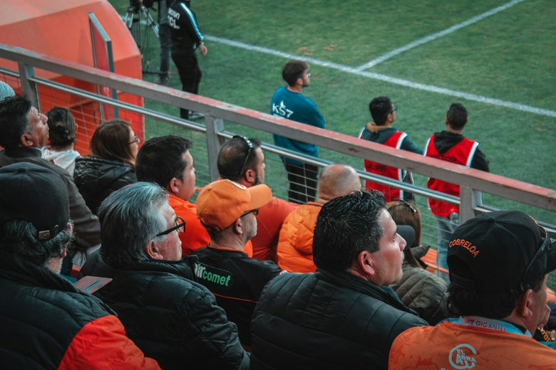 a group of people sitting on top of a soccer field