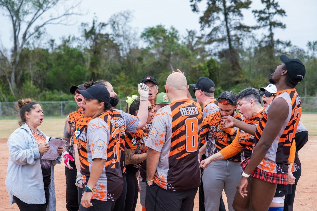A group of people standing on top of a baseball field