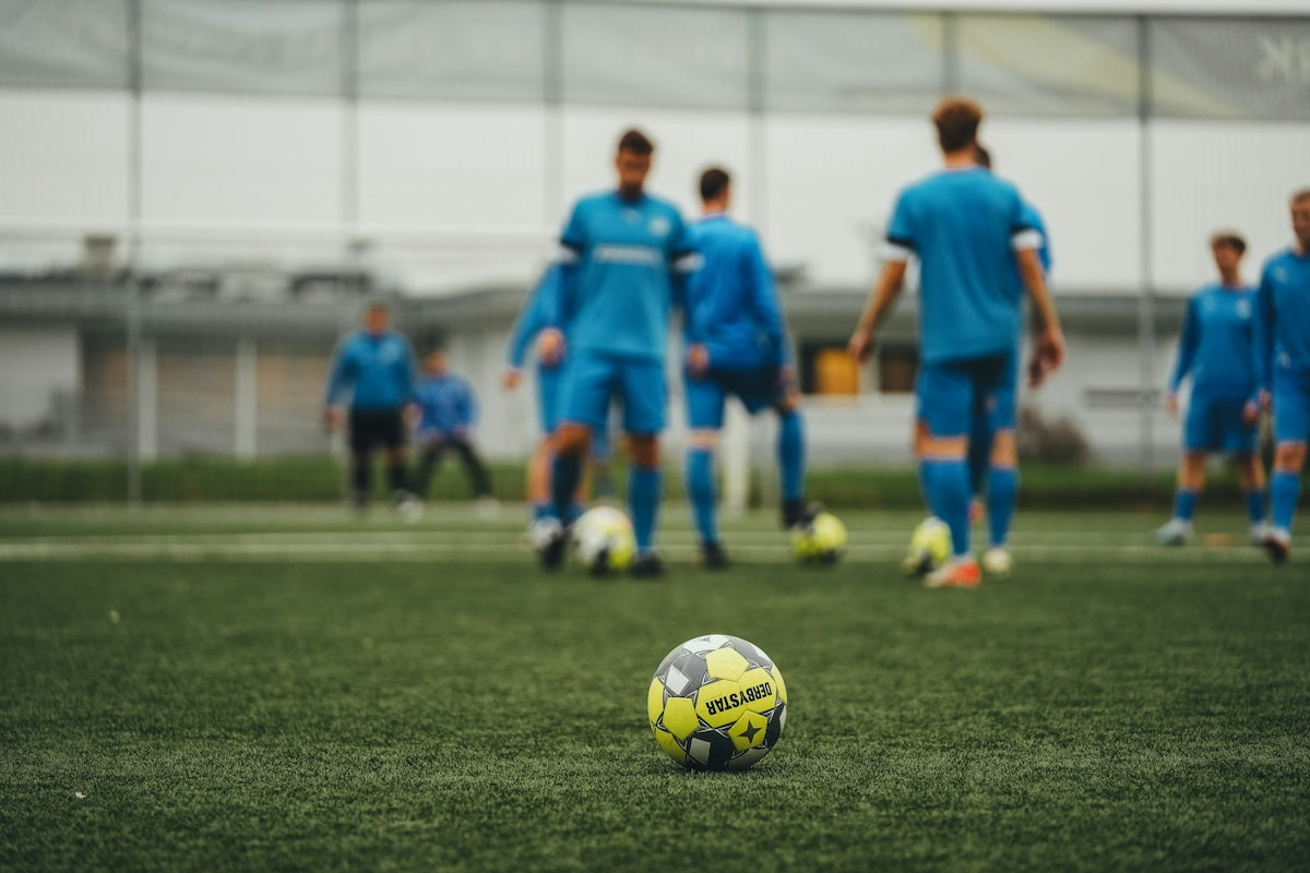 A group of young men playing a game of soccer