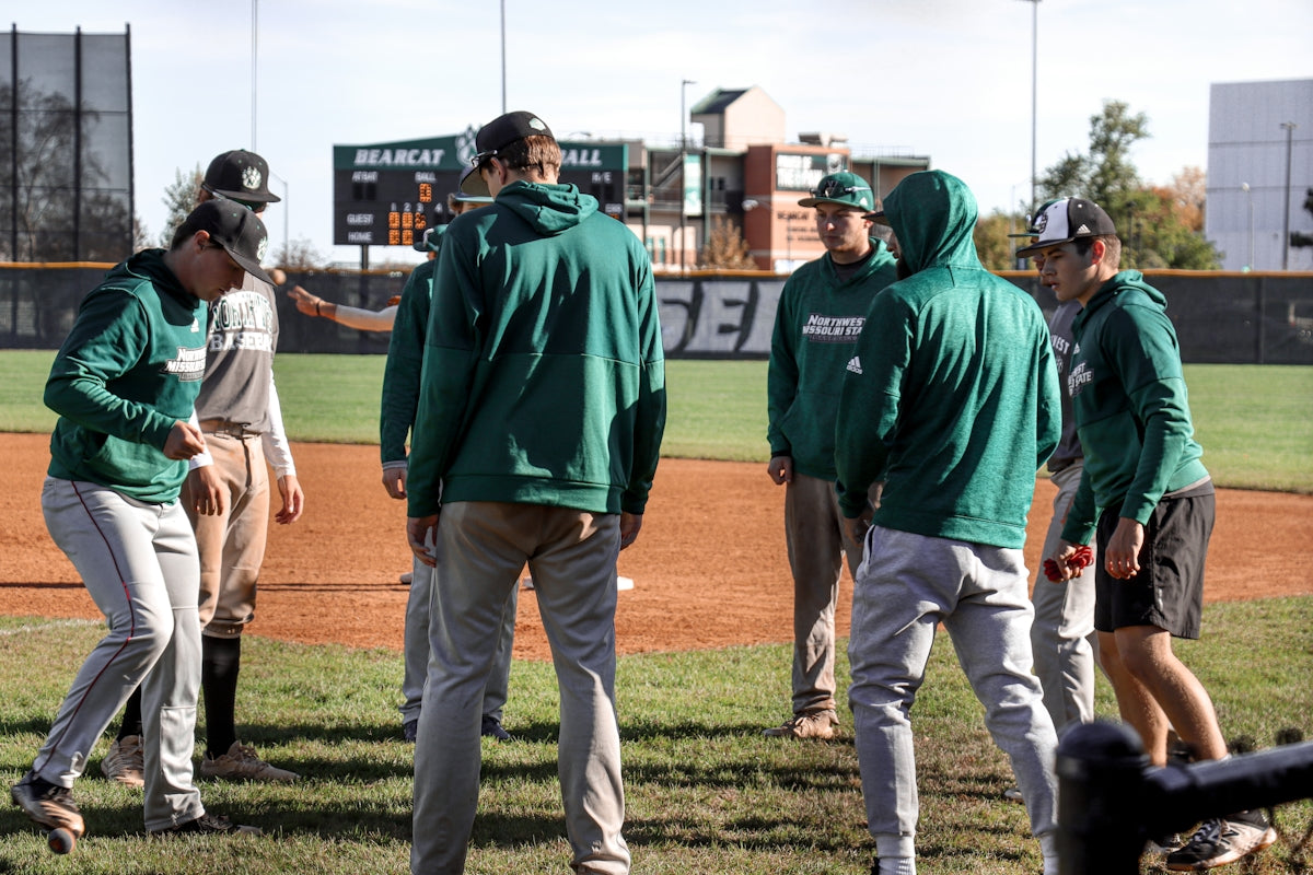 A group of men standing on top of a baseball field