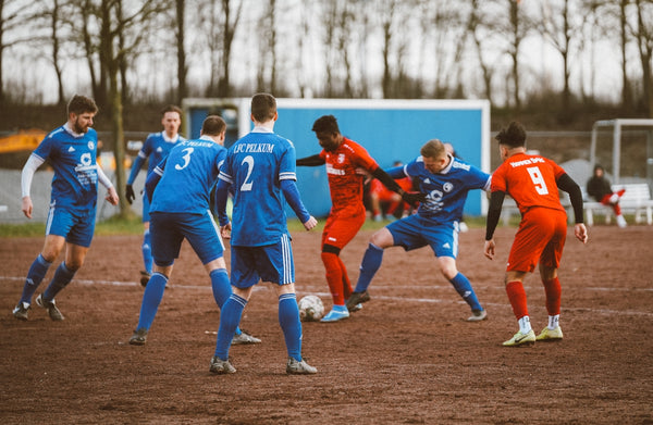 A group of young men playing a game of soccer