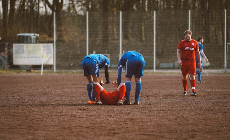 A group of men standing on top of a soccer field