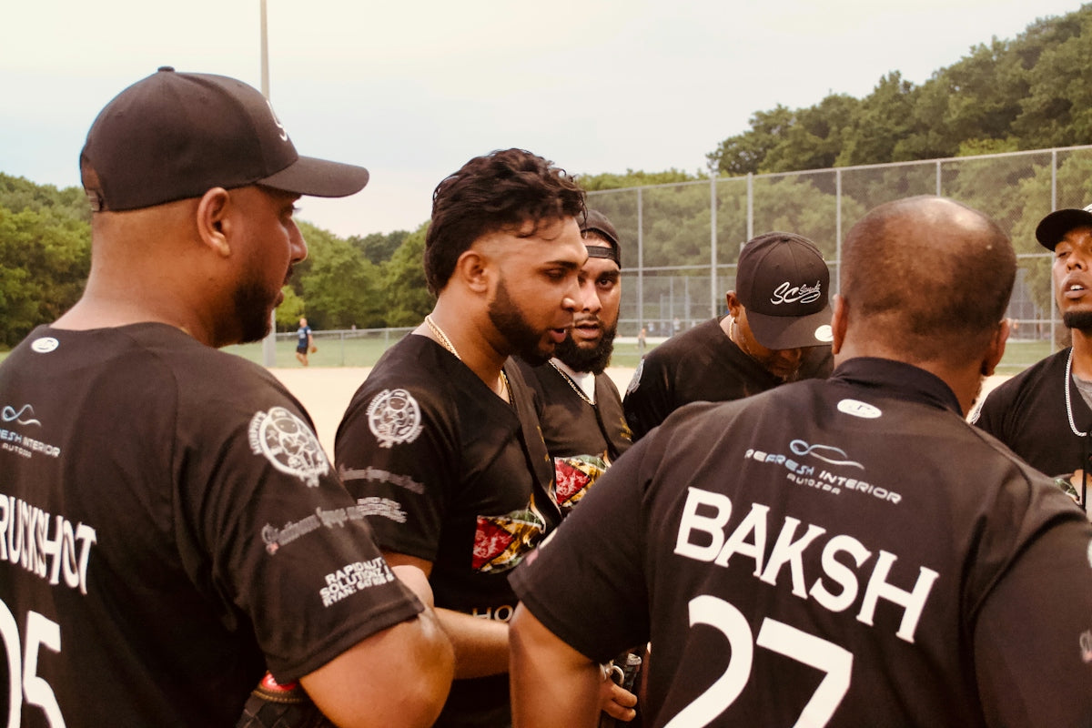 A baseball team huddles together on the field