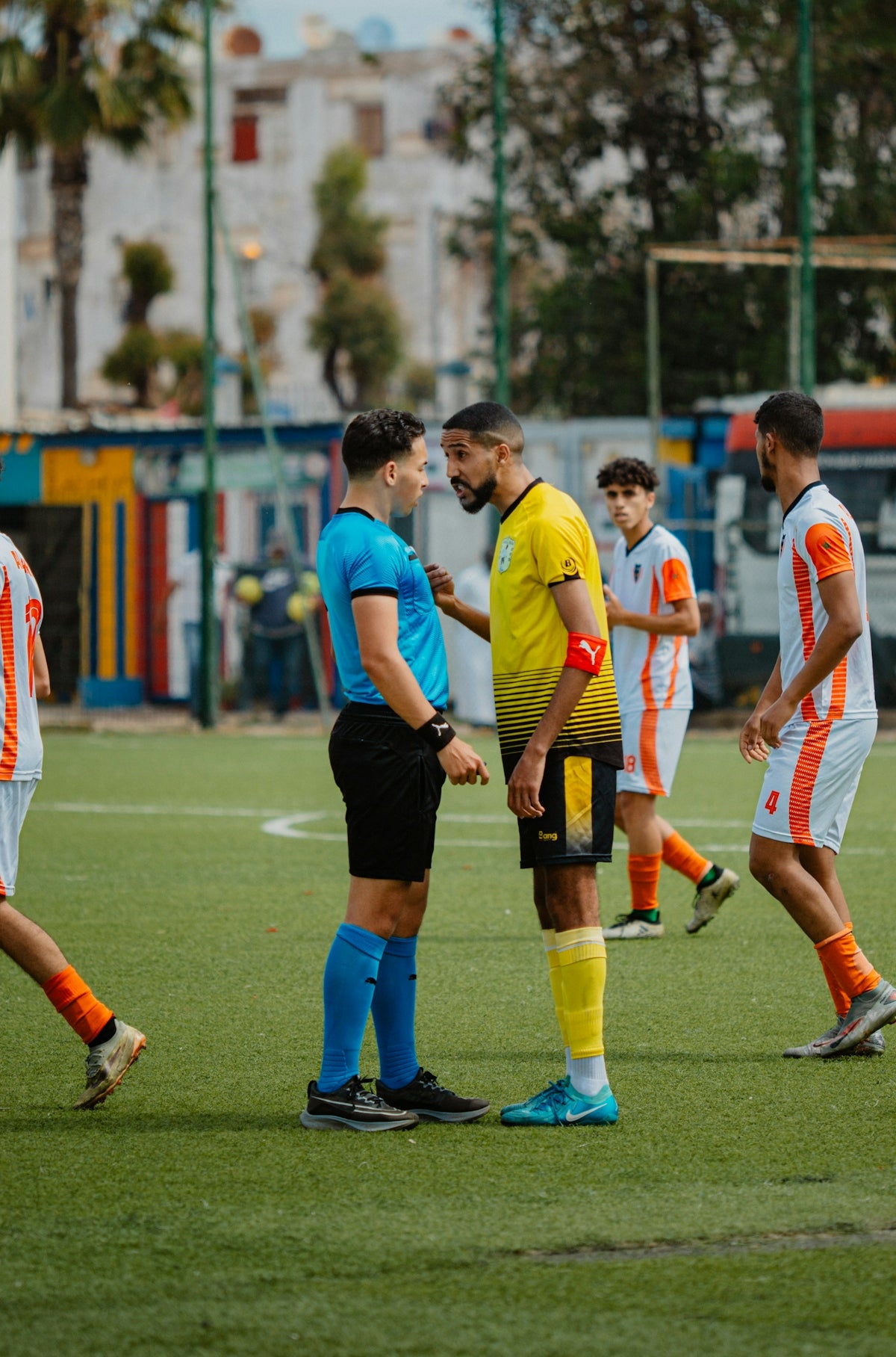 A referee and player face off during soccer game.
