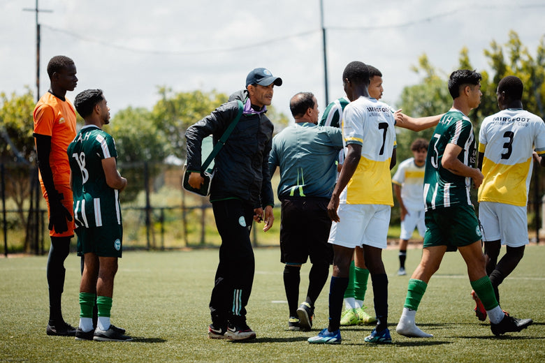 Soccer coach gives instructions to his team.